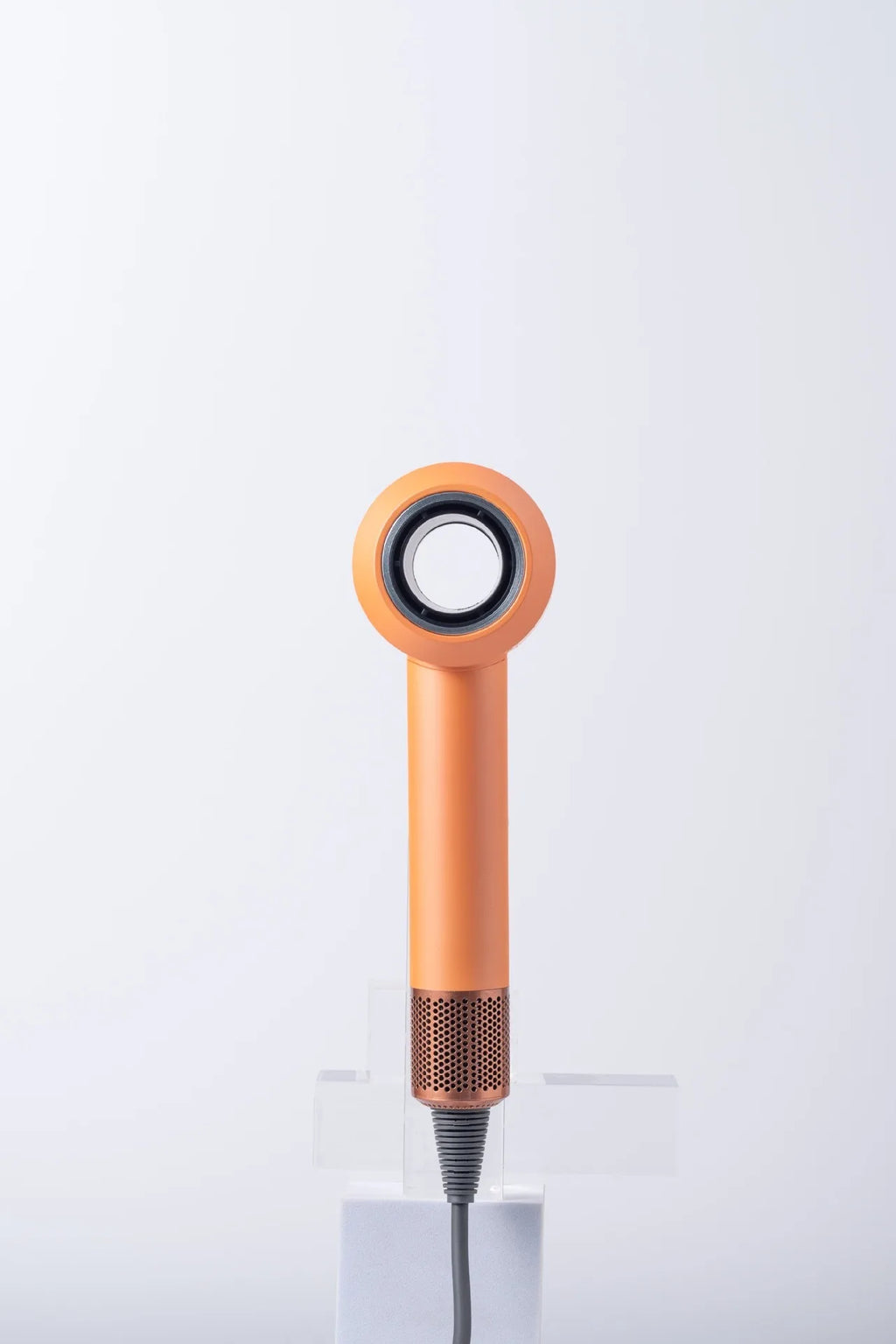 Orange high-speed bladeless hair dryer with negative ion tech and copper mesh base for professional household styling.