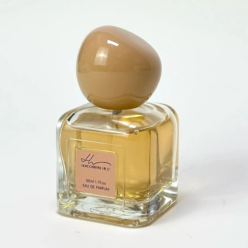 Hope Christine 50ml eau de parfum in a square glass bottle with a large, round, tan-colored cap.