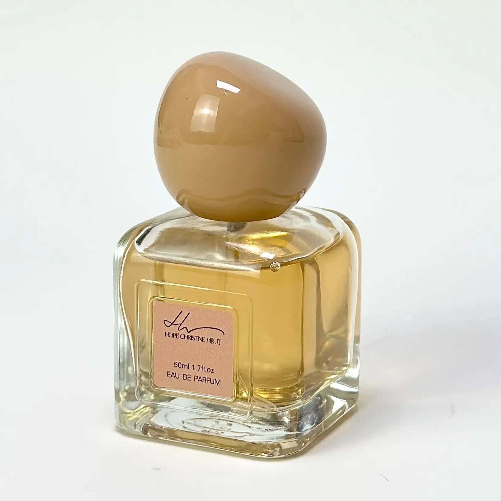 Hope Christine 50ml eau de parfum in a square glass bottle with a large, round, tan-colored cap.