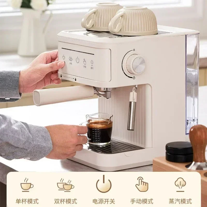 Cream-colored compact espresso coffee machine with milk steamer, cup warmer, and digital touch controls on kitchen top.