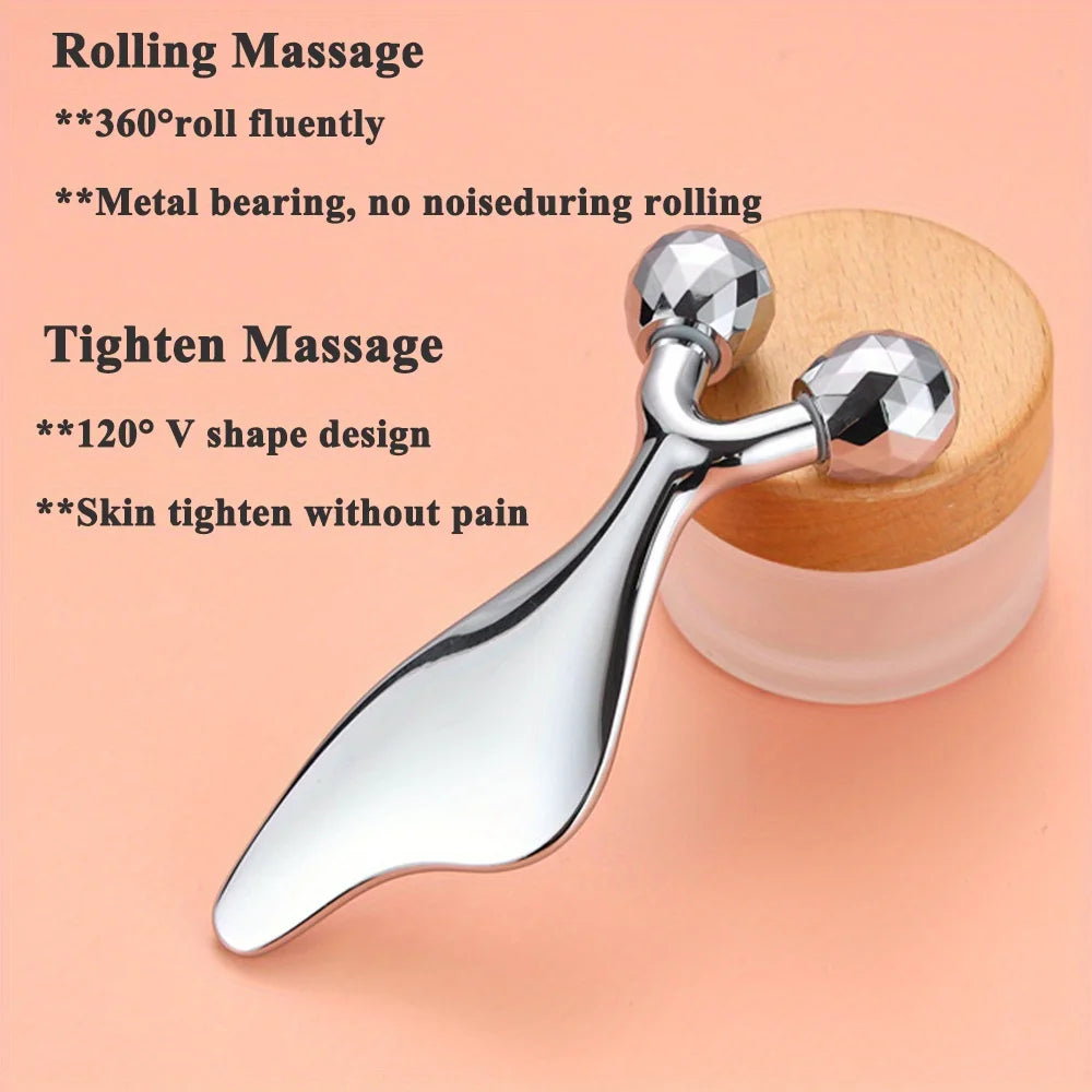 Silver 2-in-1 facial roller and Gua Sha tool with faceted spheres and a smooth, ergonomic handle on a peach background.