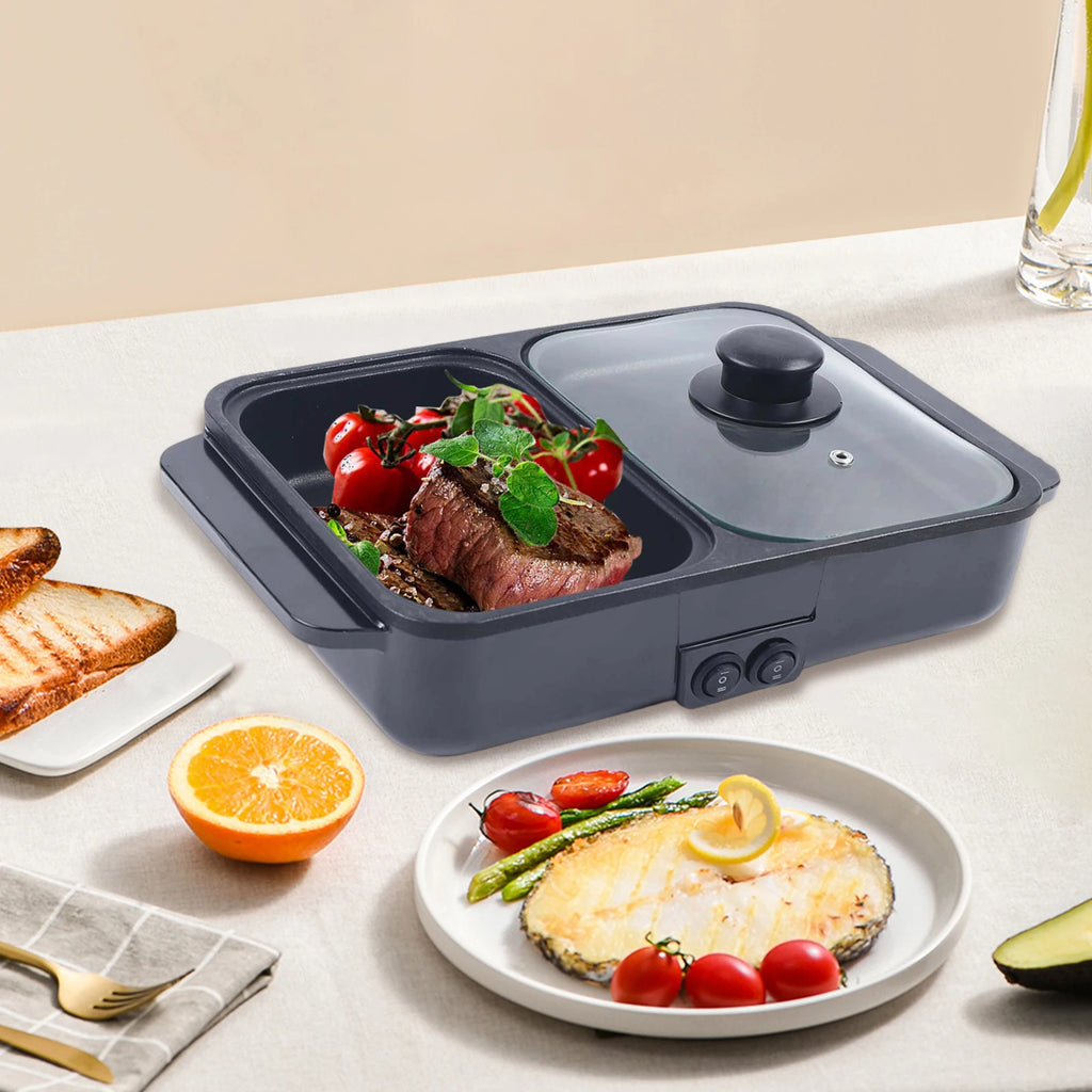 Black 2-in-1 hot pot and grill with glass lid and dual nonstick cooking zones with food