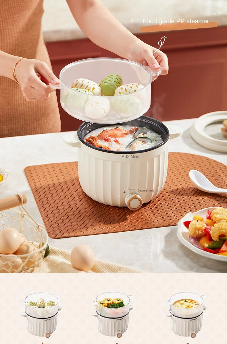 White electric rice cooker with clear steamer lid open and non-stick inner pot