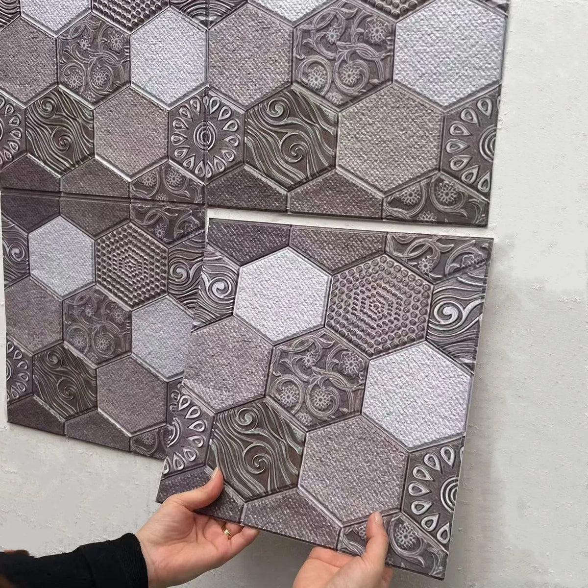 Peel-and-stick backsplash tiles with geometric octagon pattern in gray and silver