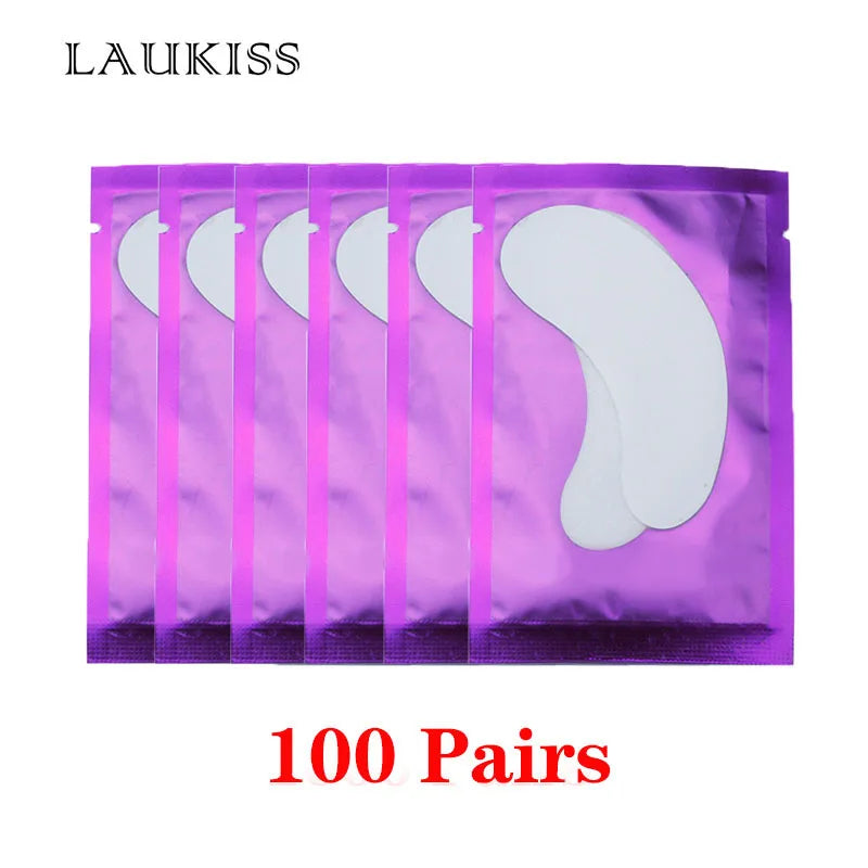 White lint-free under-eye gel patches for eyelash extensions in shiny purple individual foil sachets.
