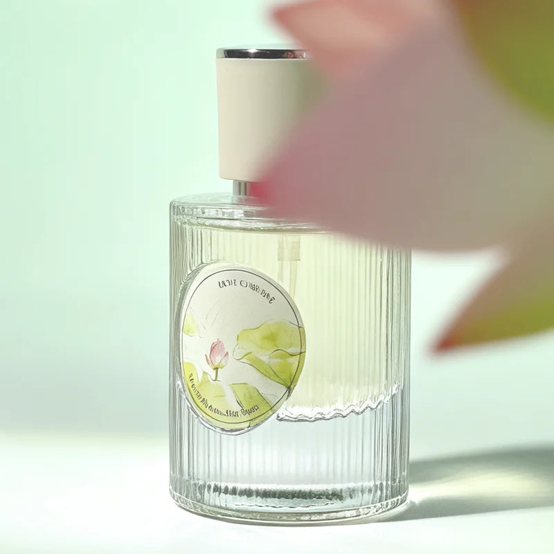 Fresh Lotus perfume in a ribbed glass bottle. Long-lasting floral woody scent with lotus and jasmine notes for women.