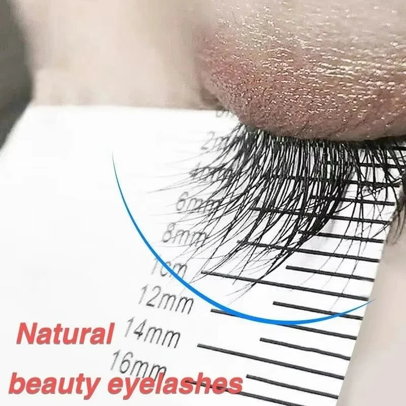 Close-up of long black eyelashes measured against a guide card to show growth results from eyelash enhancer serum.