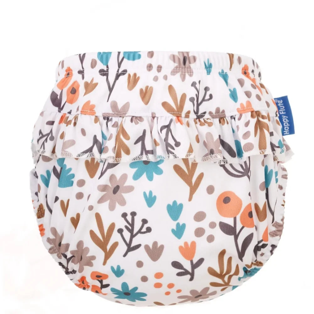 Happy Flute reusable baby cloth diaper with ruffled trim and colorful floral botanical print.