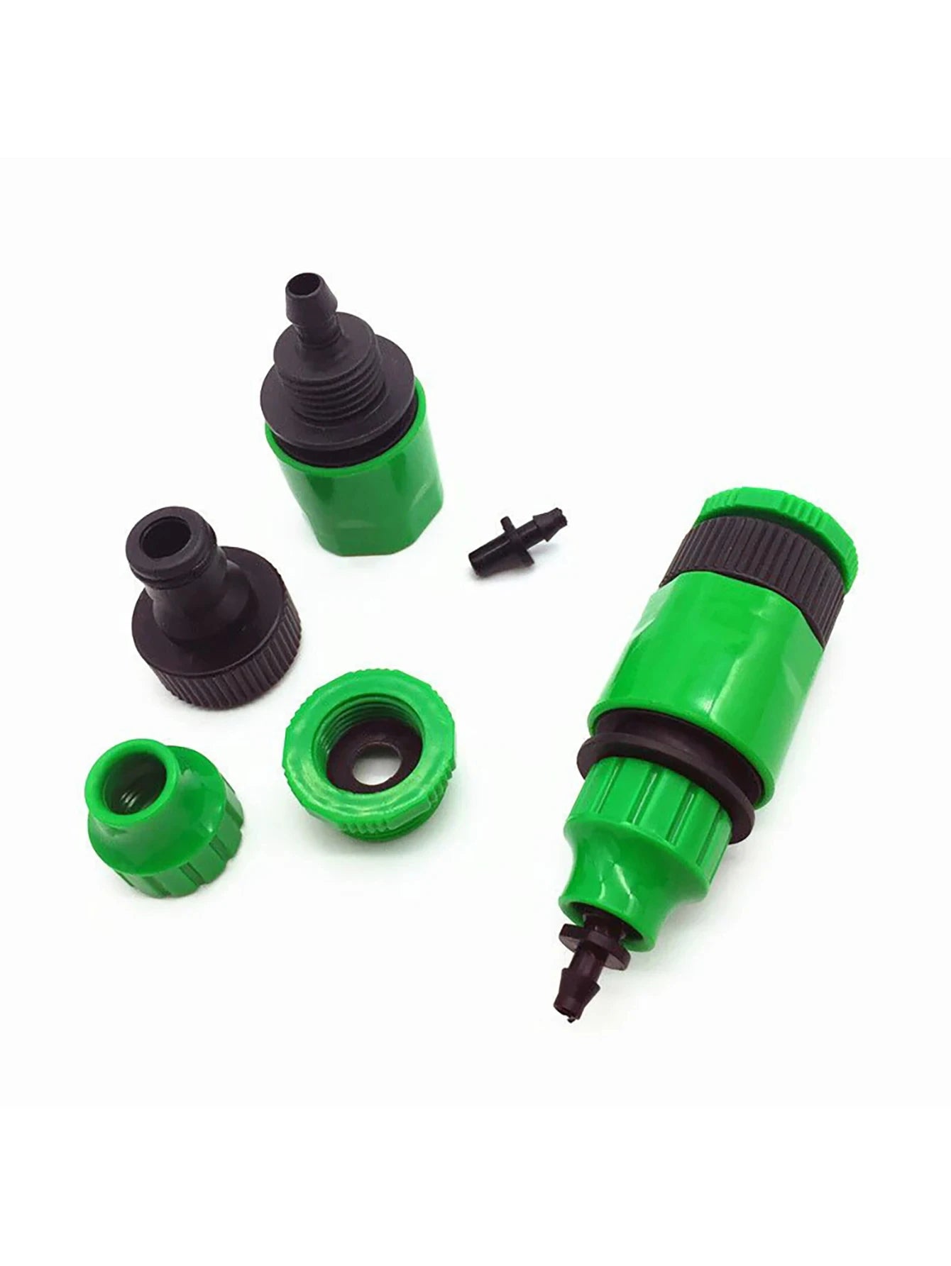 Assorted green and black quick coupling adapter parts with barbed connector and caps