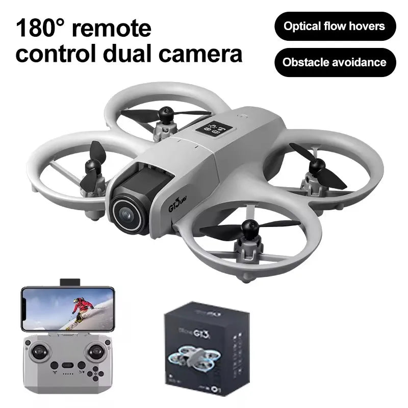 Gray mini drone with propeller guards, front camera, remote controller with phone mount, and product box.