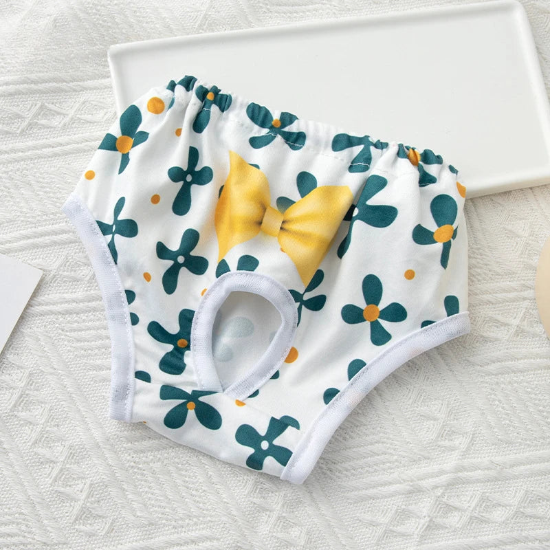 Washable floral print dog diaper with yellow bow for female dogs, reusable sanitary panties for pet heat protection.