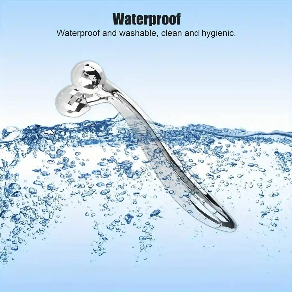 Silver Y-shaped 3D facial massage roller with faceted rotating spheres, partially submerged in clear water.