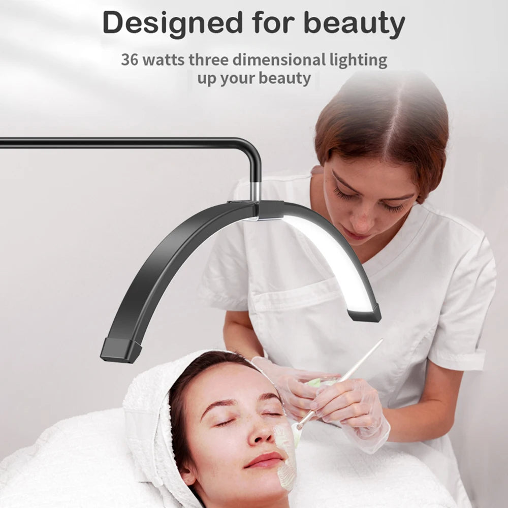 Black semi-circle LED beauty lamp on an adjustable arm, providing focused lighting for a facial spa treatment.
