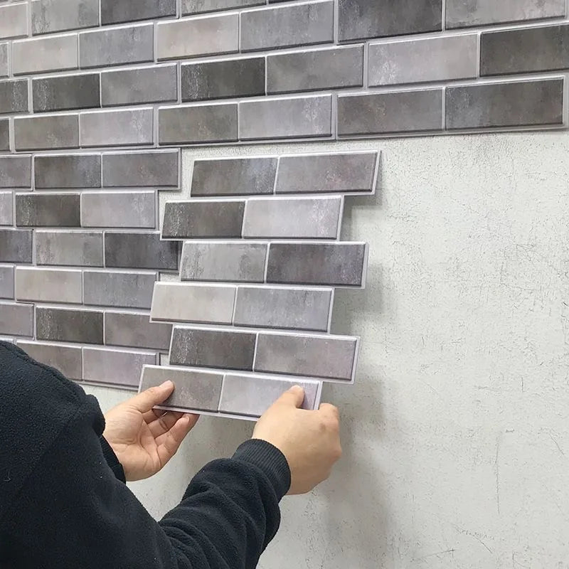 Peel-and-stick brick tile backsplash, gray stacked-stone tiles shown being applied