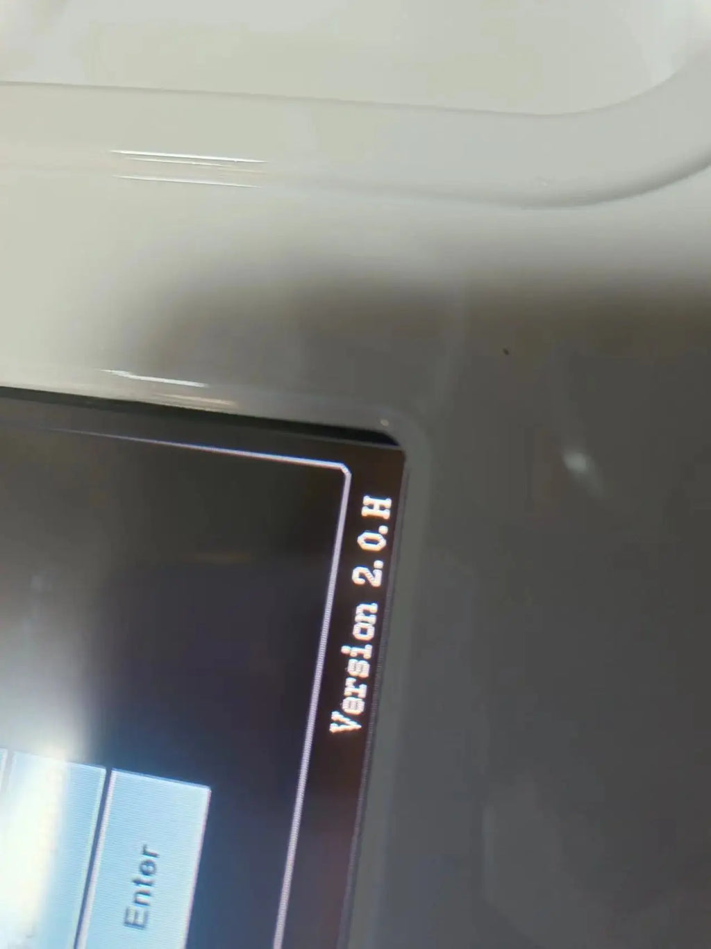 Close-up of a white HIFU machine's digital screen displaying "Version 2.0.H" and an "Enter" button.