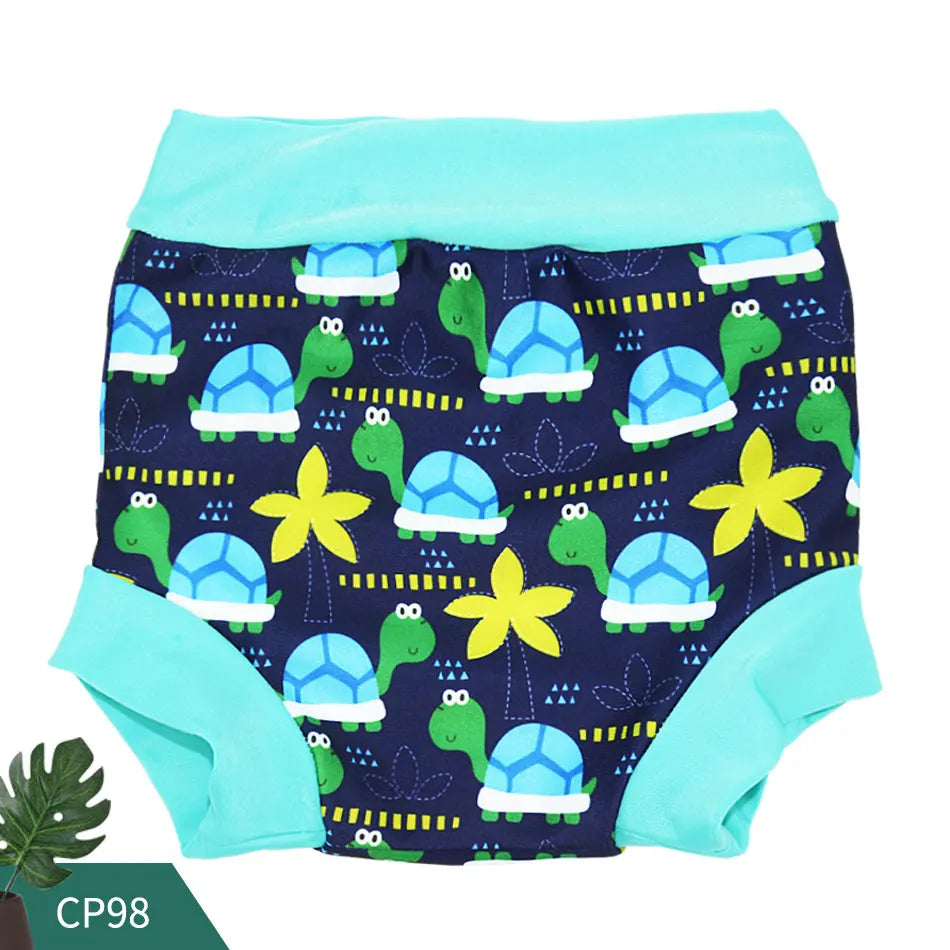 Reusable baby swim diaper, model CP98, featuring a navy blue turtle and palm tree print with teal trim.