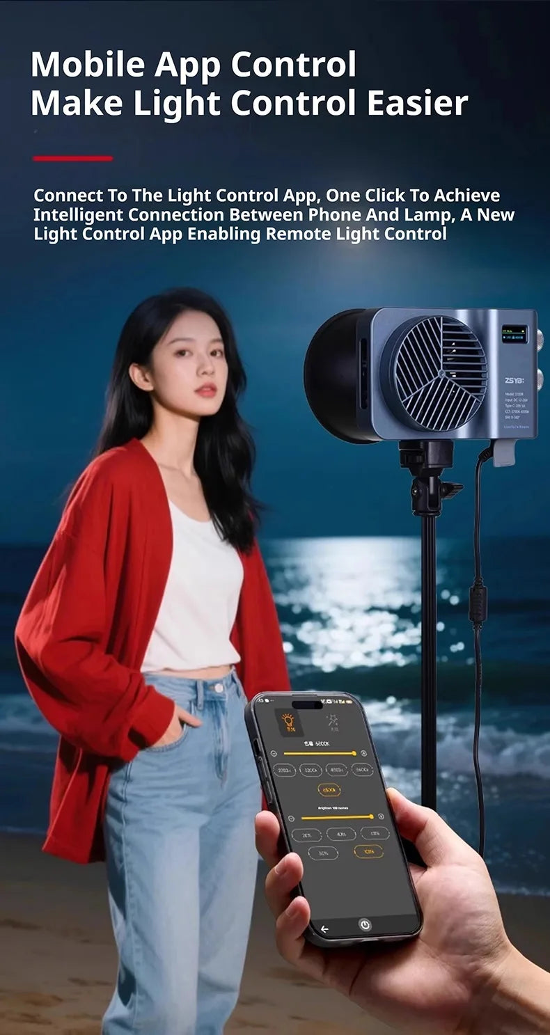 A grey compact LED video light on a tripod, controlled by a smartphone app to adjust lighting settings.