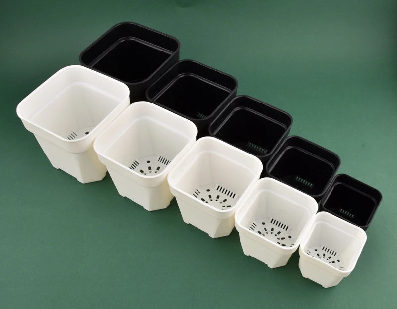 Mixed square plant pots in white and black with vented drainage bases