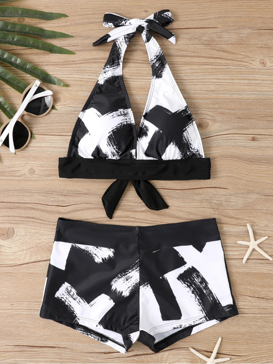 Tidesmit high-waisted bikini in black and white brushstroke print with a halter neck, tie front, and padded top.