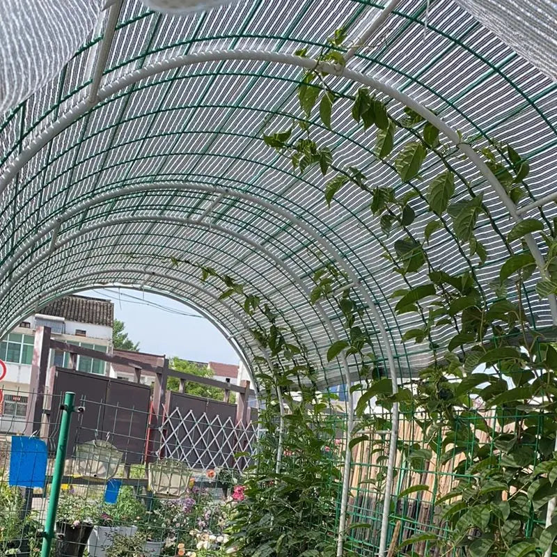 Aluminum foil sunshade net tunnel covering greenhouse plants, arched silver reflective mesh
