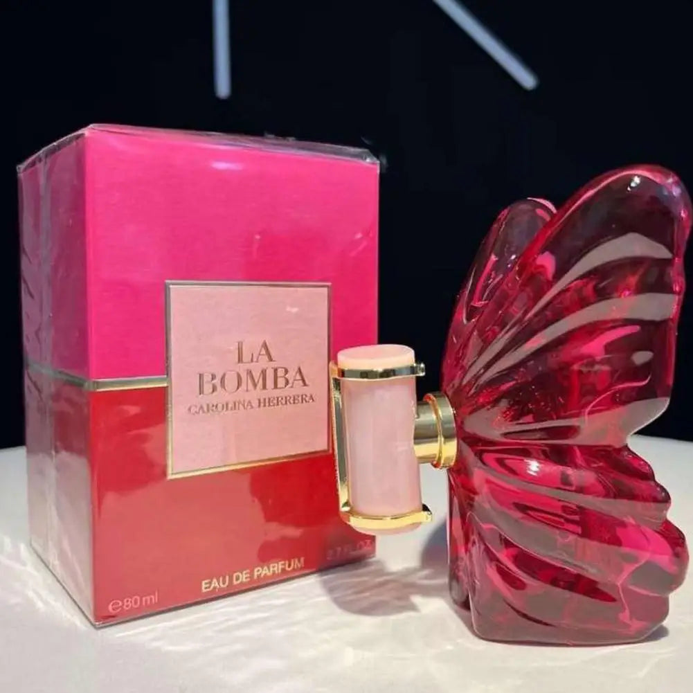 Carolina Herrera La Bomba EDP: Unisex fruity floral perfume in a red glass butterfly-shaped bottle with pink box.