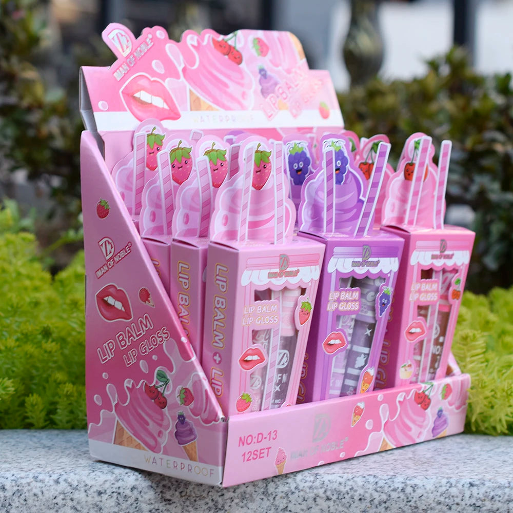 Cute ice cream-themed lip gloss and balm set in a pink display box with strawberry and grape fruit illustrations.