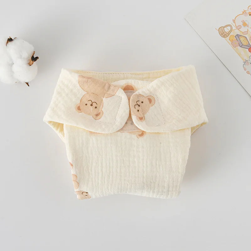 Soft cream muslin cotton baby diaper with cute bear print, reusable baby care essential.