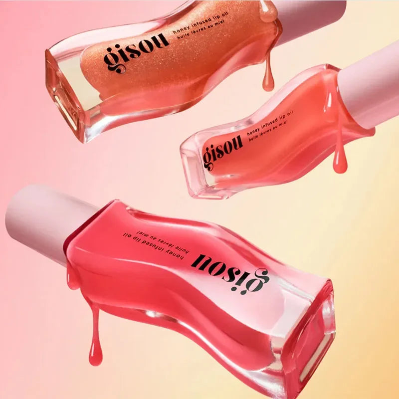 Gisou Honey Infused Lip Oil set in glazed plum and pink shades with a high-shine, nourishing, glossy texture.