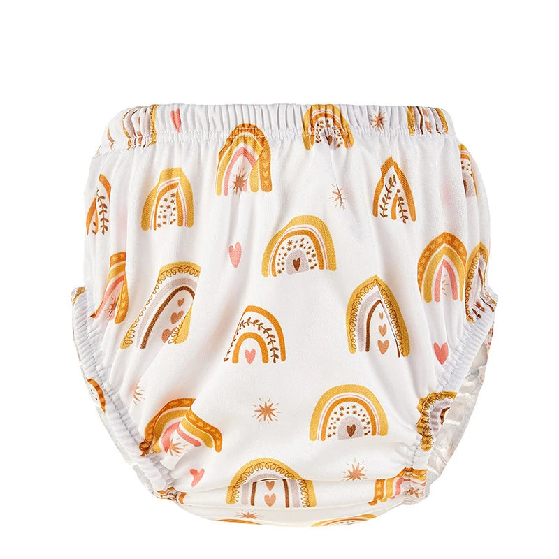 Reusable baby cloth swim diaper with yellow and pink boho rainbow print on white background.