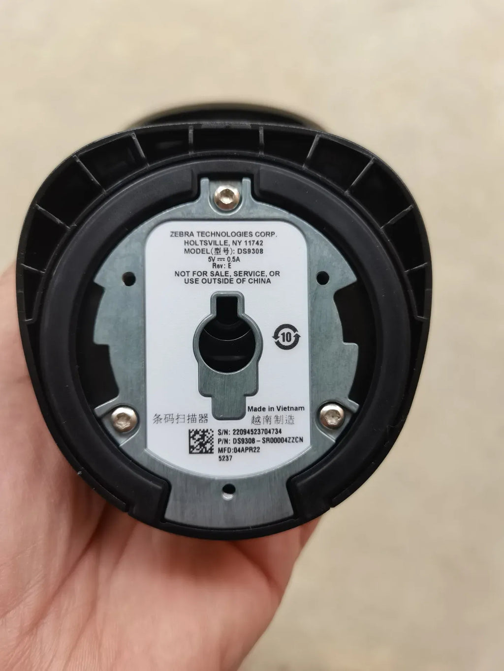 Zebra DS9308 scanner base with label, circular underside and mounting key