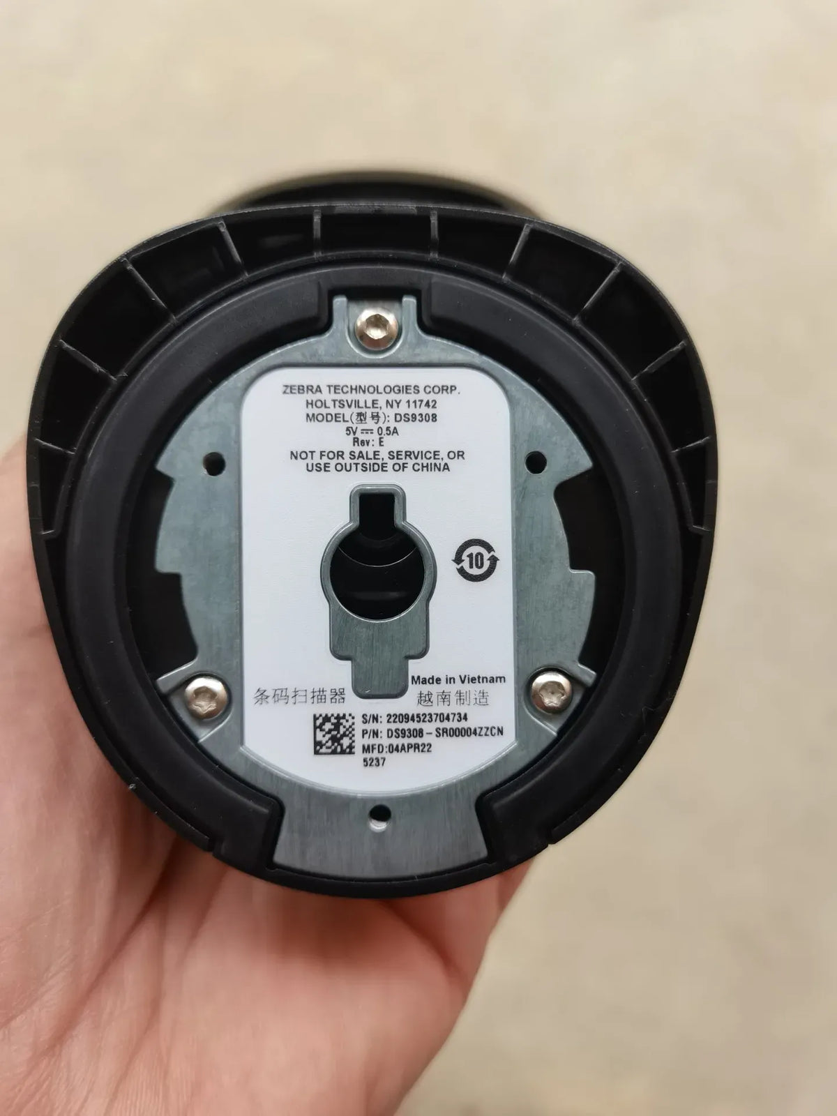 Zebra DS9308 scanner base with label, circular underside and mounting key