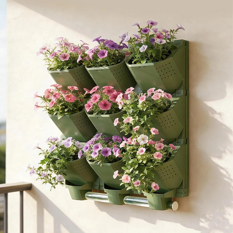 Green modular vertical garden planter wall with multiple potted flower plants