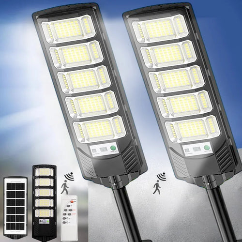 Black solar LED street light with multi-panel LED array and motion sensor