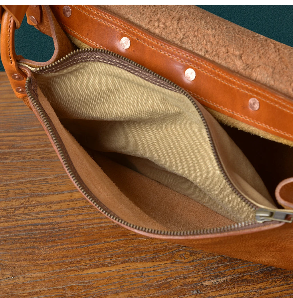Vintage tan genuine cowhide leather messenger bag, handmade designer shoulder bag with canvas lining and rivet details.