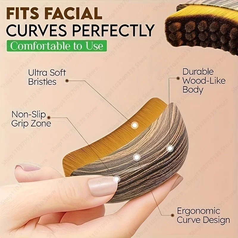 Ergonomic lymphatic face brush with a wood-grain finish, soft bristles, and a curved, non-slip body held in a hand.