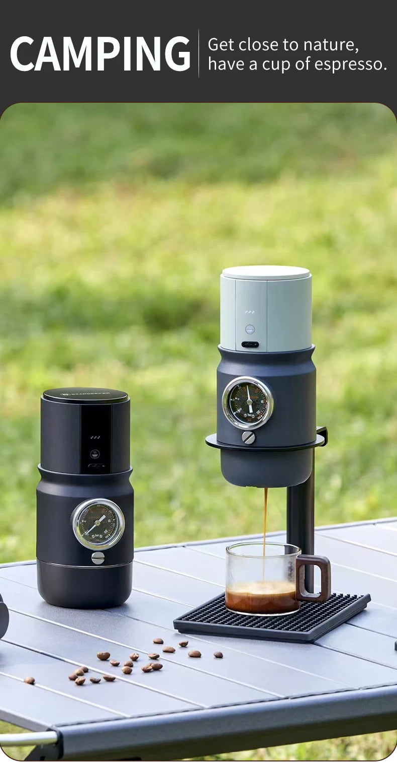 Portable espresso maker set for camping with pressure gauge, sleek matte black and grey finish on outdoor table.