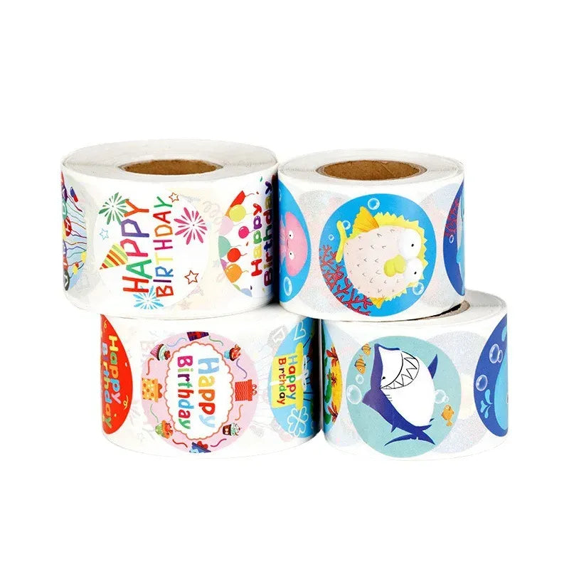 Rolls of colorful birthday-themed circle sticker labels with adhesive backing.
