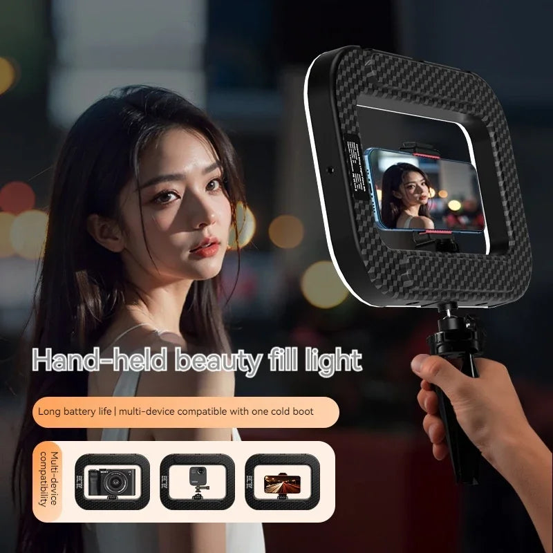 Square carbon-fiber handheld fill light with a phone mount and tripod grip for mobile photography and video streaming.