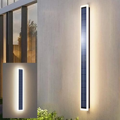Long vertical black solar wall light with integrated LED border, mounted on exterior wall.