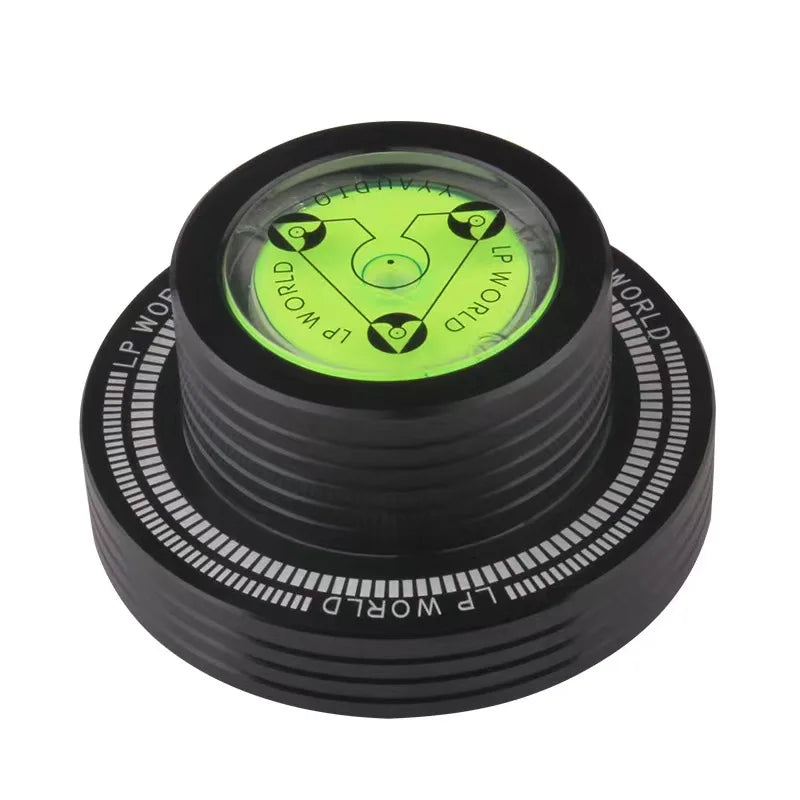 Black vinyl record stabilizer weight with green center label and concentric rings
