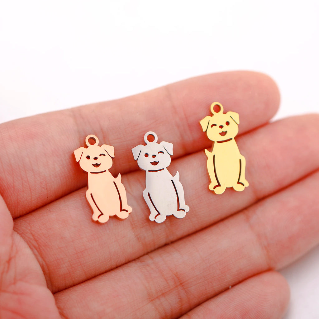 Three stainless steel dog charms in gold, silver, and rose gold for DIY pet-themed jewelry making.