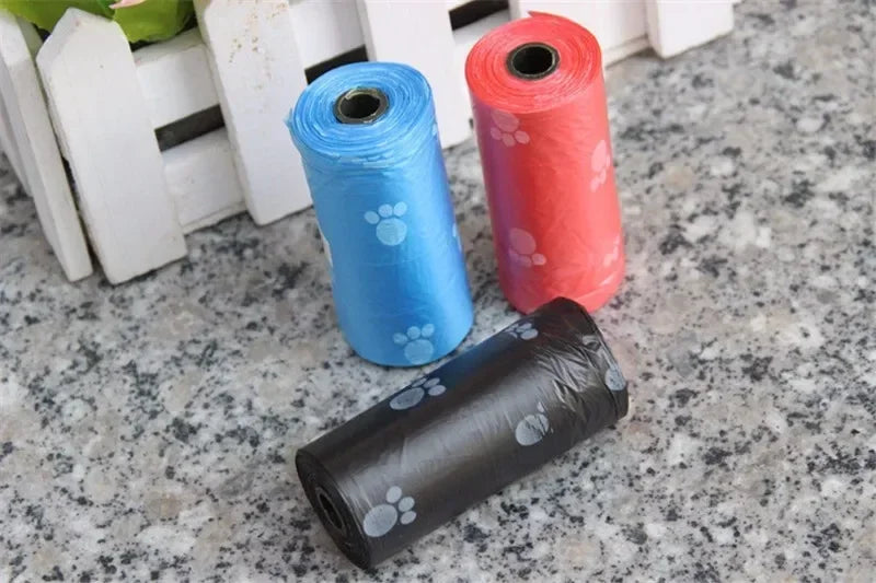 Colorful rolls of leak-proof dog poop bags with cute cartoon paw prints for easy, clean pet waste disposal.