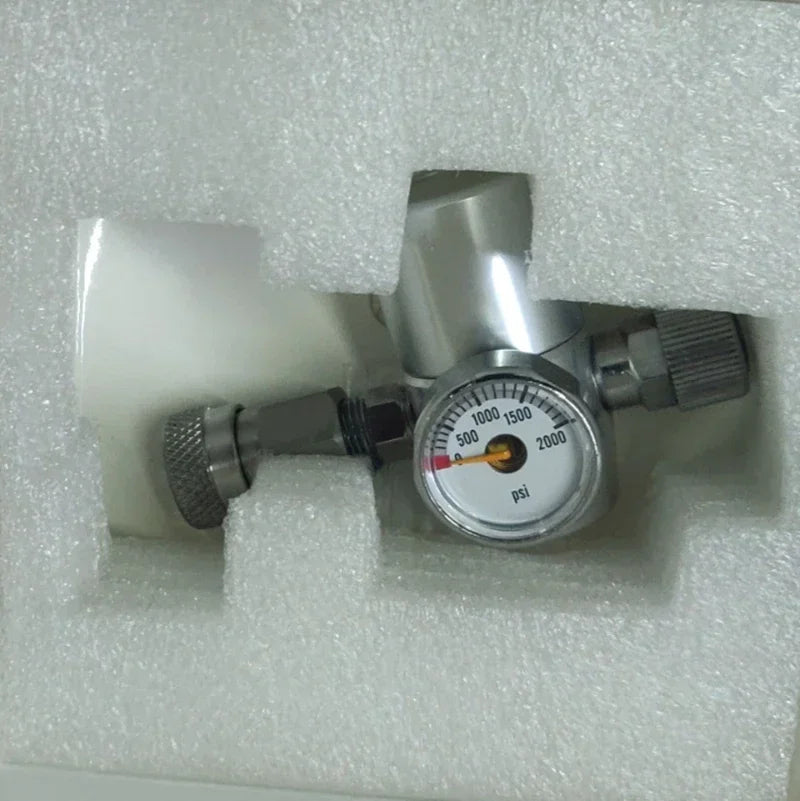 Silver chrome espresso coffee maker pressure gauge attachment in protective white foam packaging.