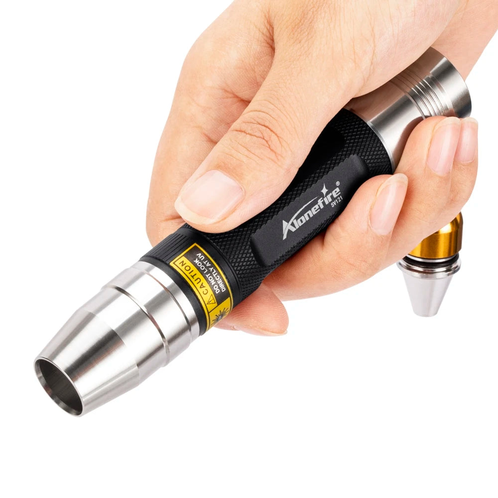 Hand holding a 3-in-1 USB rechargeable UV flashlight for detecting pet stains and cleaning messes.