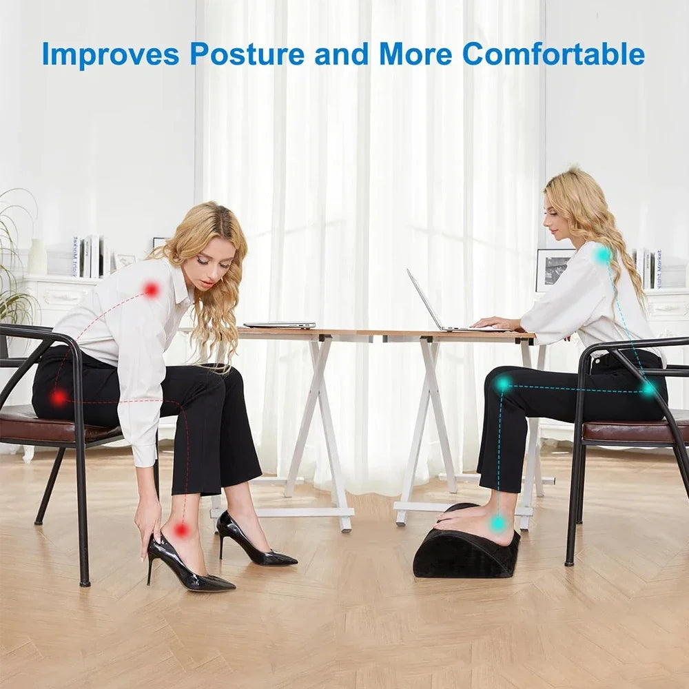 Black memory foam under-desk foot rest improving posture for office work with a washable, removable cover.