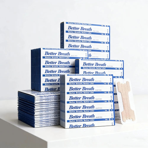 Better Breath nasal strips for sleep apnea in blue and white boxes with tan adhesive nasal strips.