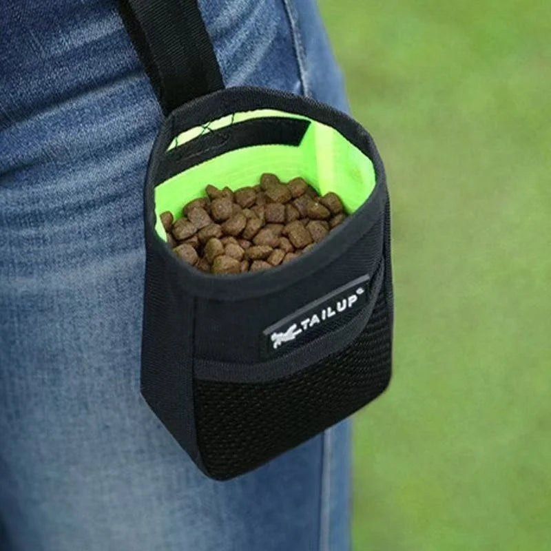 Black pet training treat pouch worn on waist for puppy obedience and agility snacks with easy-access green interior.