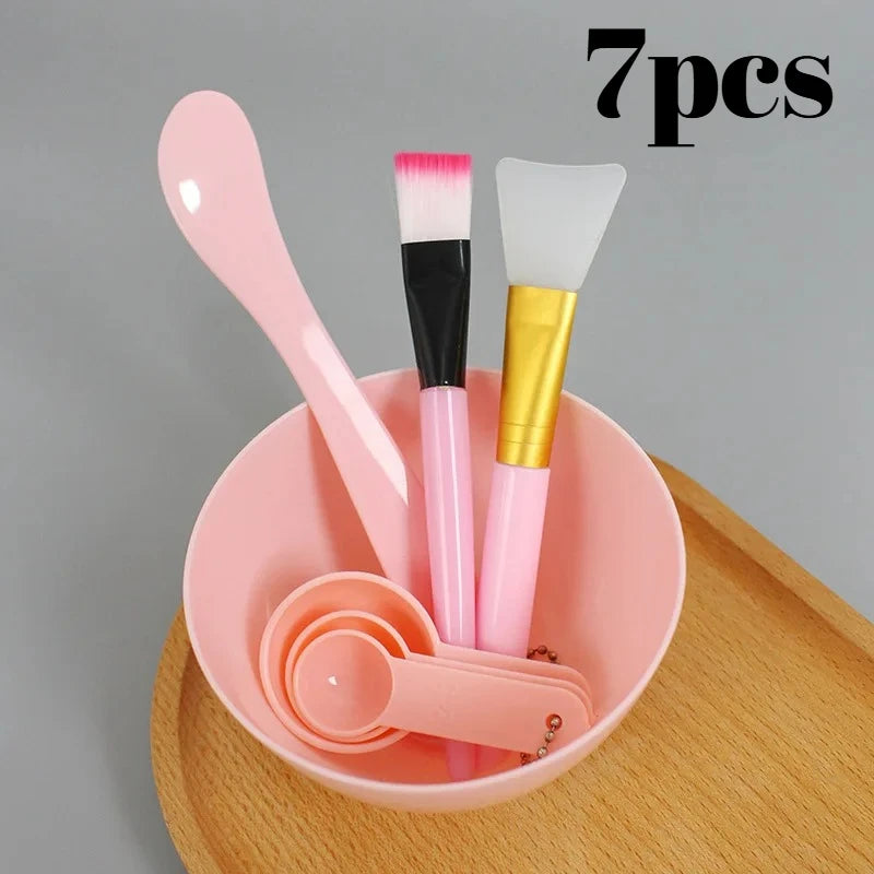 7-piece pink facial mask DIY tool kit with mixing bowl, spatulas, brushes, and measuring spoons.