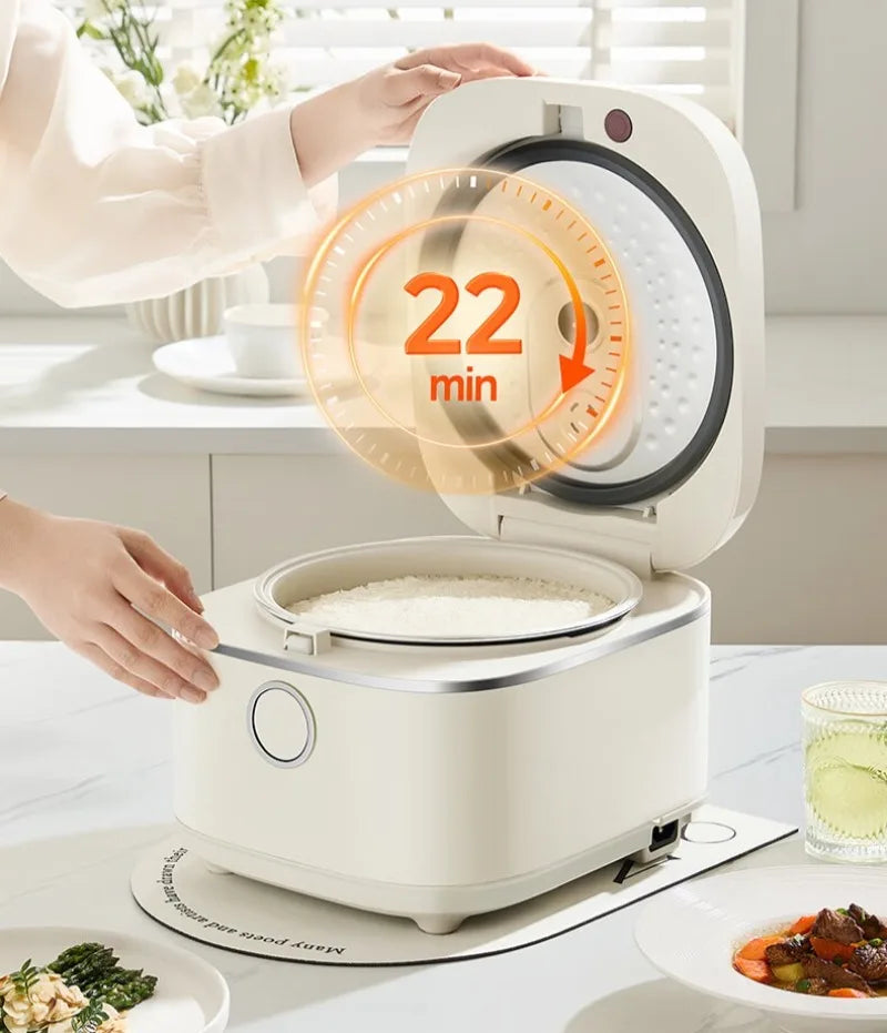 White rice cooker with open lid and steaming rice visible inside