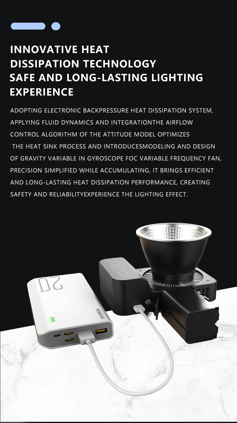 Portable LED studio light with cooling fan, connected via USB cable to a white rectangular power bank on marble surface.